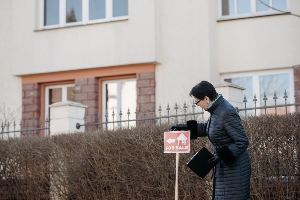 Free A Woman in Black Jacket Looking at the Sign on the Street Stock Photo